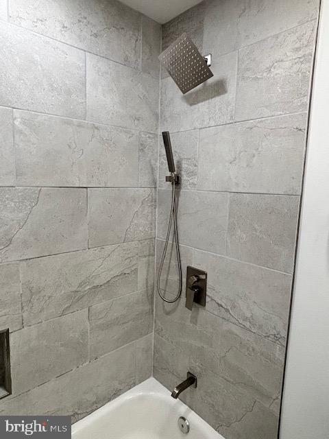 bathroom featuring tiled shower / bath