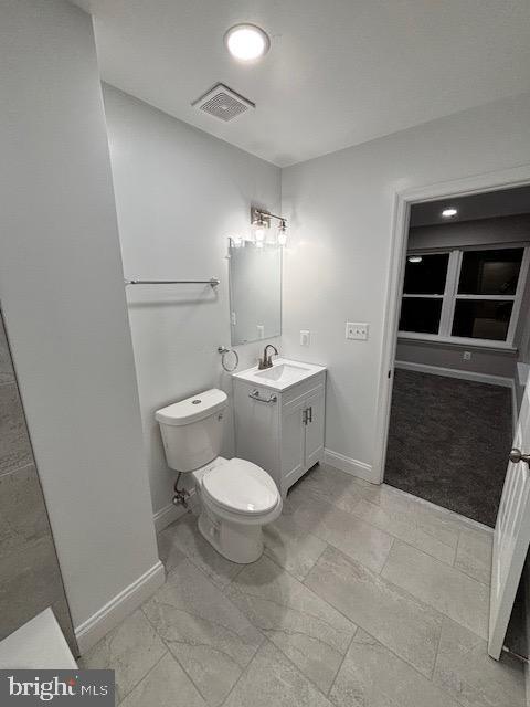 bathroom with vanity and toilet