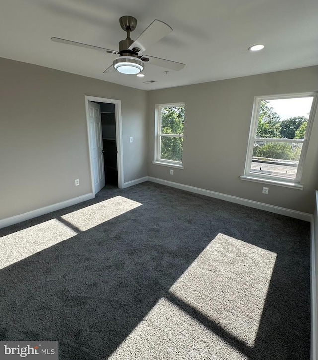 carpeted empty room featuring ceiling fan