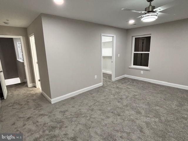 empty room featuring carpet floors and ceiling fan