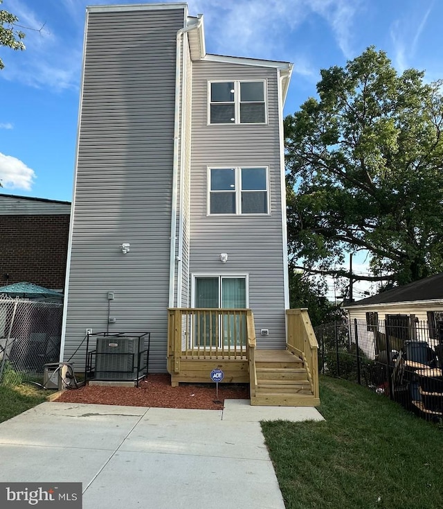 rear view of property featuring a lawn