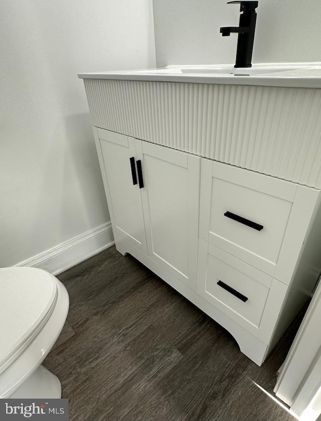 bathroom featuring sink, hardwood / wood-style floors, and toilet