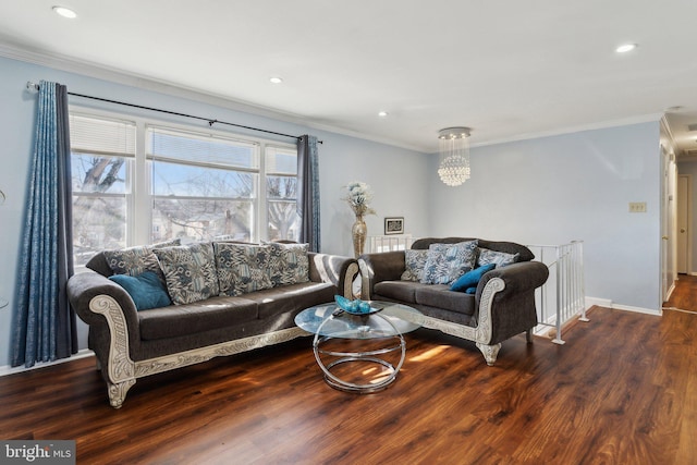 living room with dark hardwood / wood-style flooring, a notable chandelier, and ornamental molding