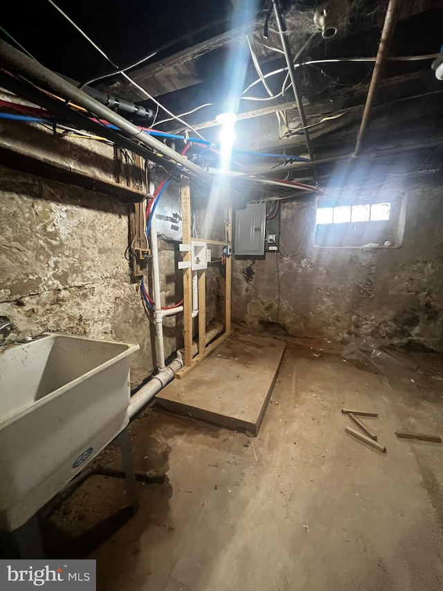 basement featuring sink and electric panel