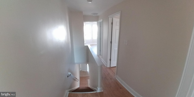 corridor with light hardwood / wood-style floors