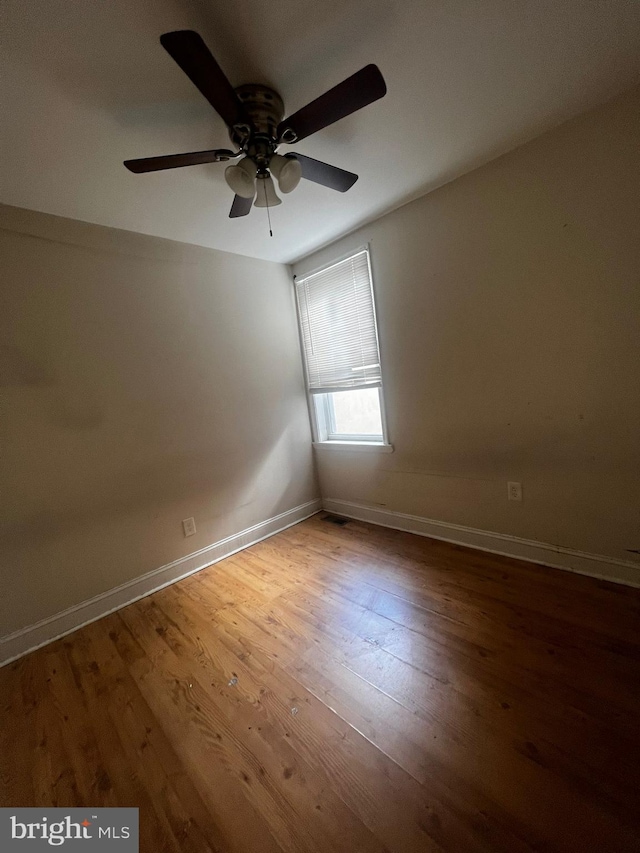 empty room featuring wood-type flooring and ceiling fan