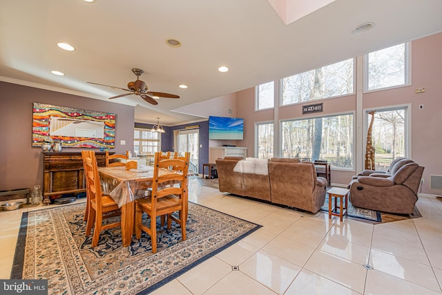 tiled dining room featuring ceiling fan, a healthy amount of sunlight, and ornamental molding