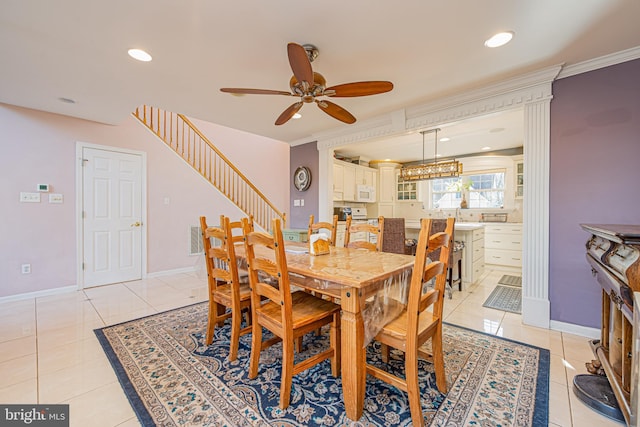 dining room featuring sink, ceiling fan, and light tile patterned flooring