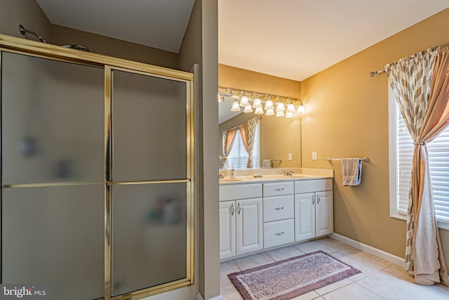 bathroom with tile patterned floors, a shower with shower door, and vanity