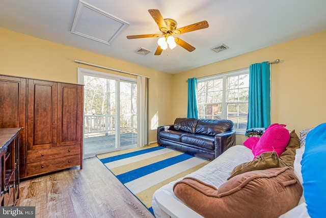 living room with ceiling fan and light hardwood / wood-style floors