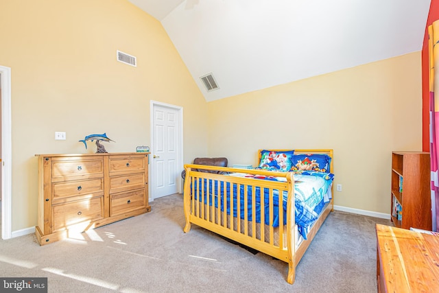 bedroom featuring high vaulted ceiling and light colored carpet