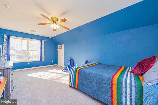 bedroom featuring carpet floors, vaulted ceiling, and ceiling fan