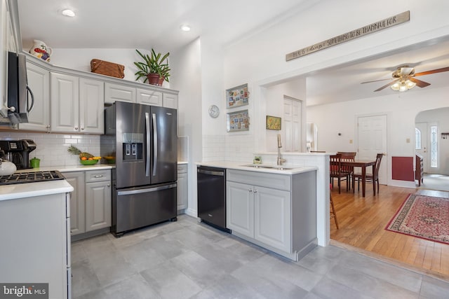 kitchen with a sink, light countertops, appliances with stainless steel finishes, and gray cabinets