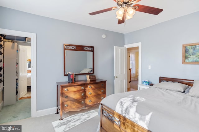 bedroom with light carpet, ceiling fan, and baseboards