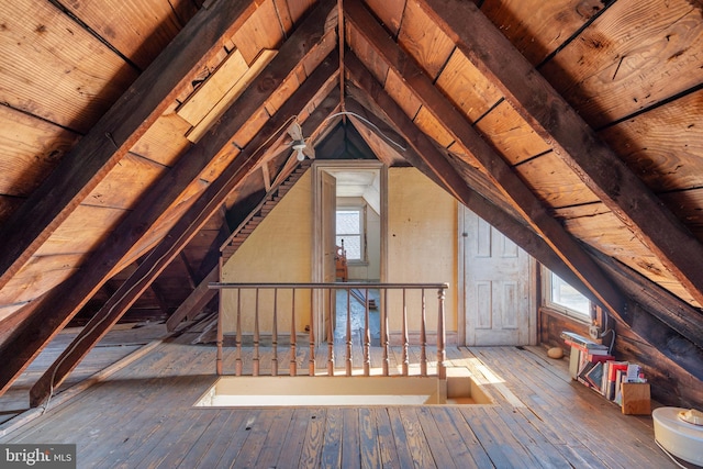 unfinished attic featuring an upstairs landing