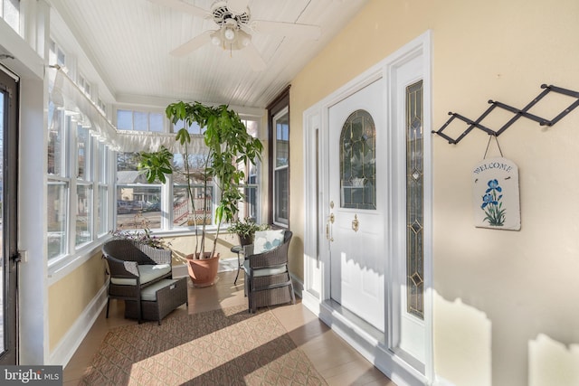 sunroom with a ceiling fan