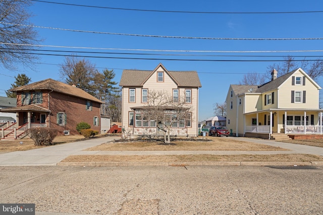 view of front of home with covered porch and a residential view