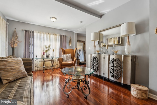 living room with beamed ceiling and dark hardwood / wood-style flooring