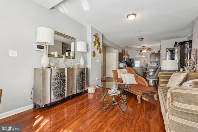 living room with ceiling fan and wood-type flooring