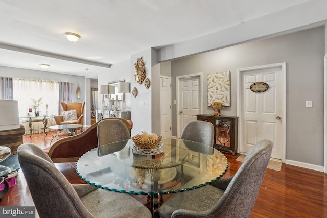 dining space with dark hardwood / wood-style flooring