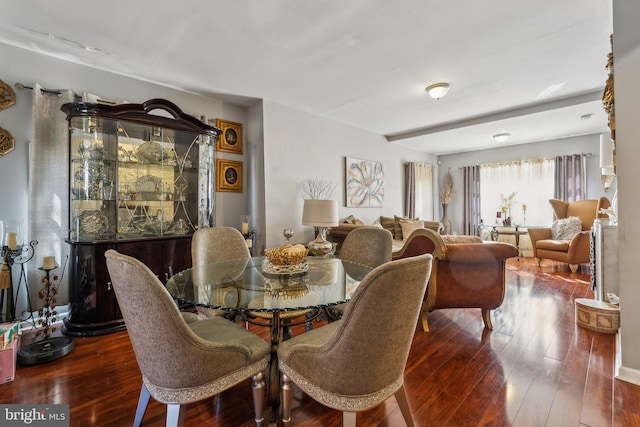 dining area with dark hardwood / wood-style flooring