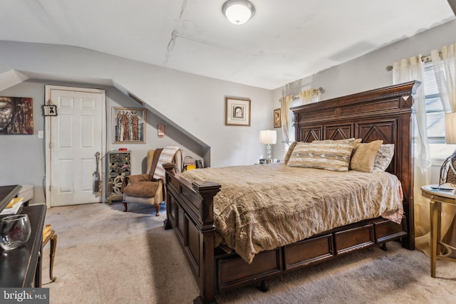 carpeted bedroom featuring vaulted ceiling