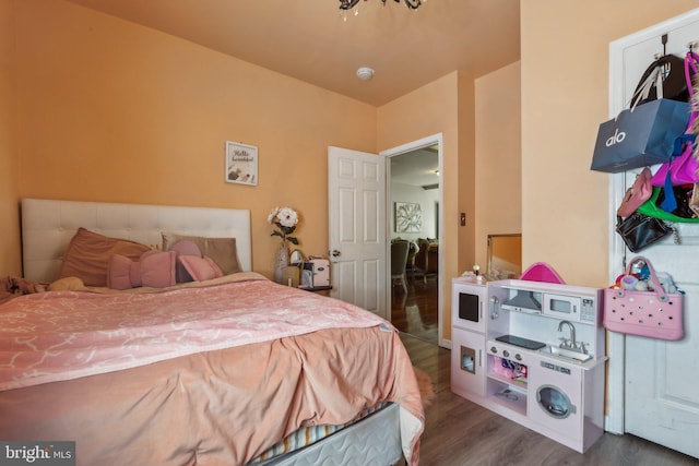 bedroom with dark hardwood / wood-style floors