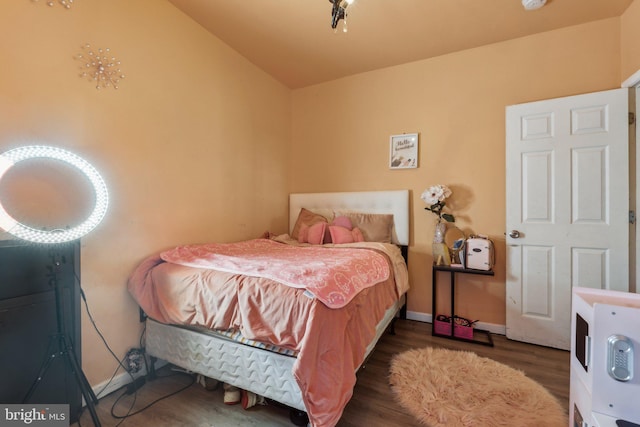 bedroom with dark wood-type flooring