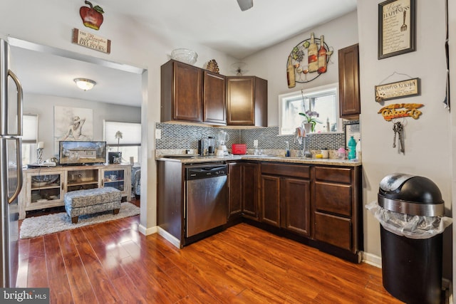 kitchen with tasteful backsplash, stainless steel appliances, dark brown cabinetry, and dark wood-type flooring