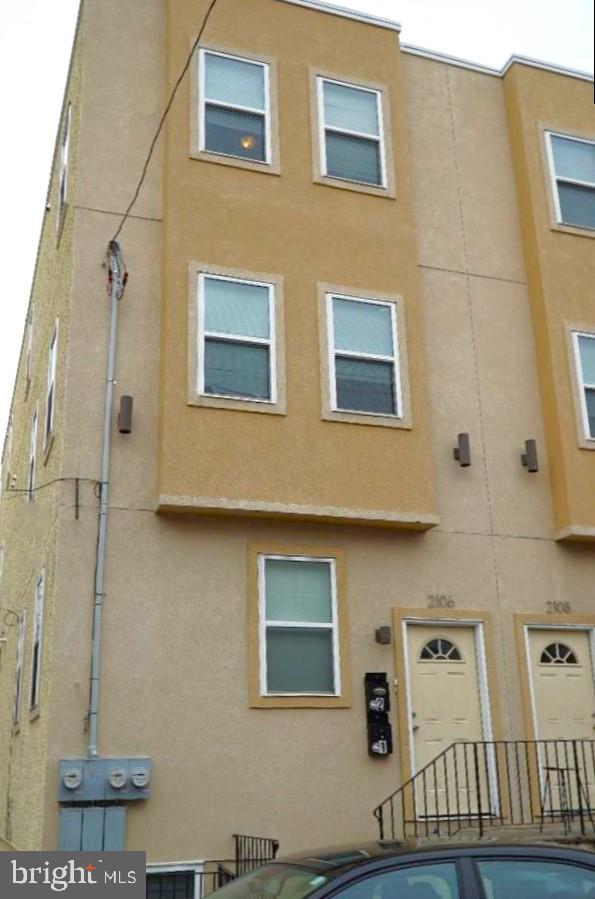 back of property featuring stucco siding