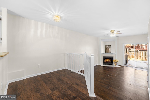 unfurnished living room featuring hardwood / wood-style flooring and ceiling fan