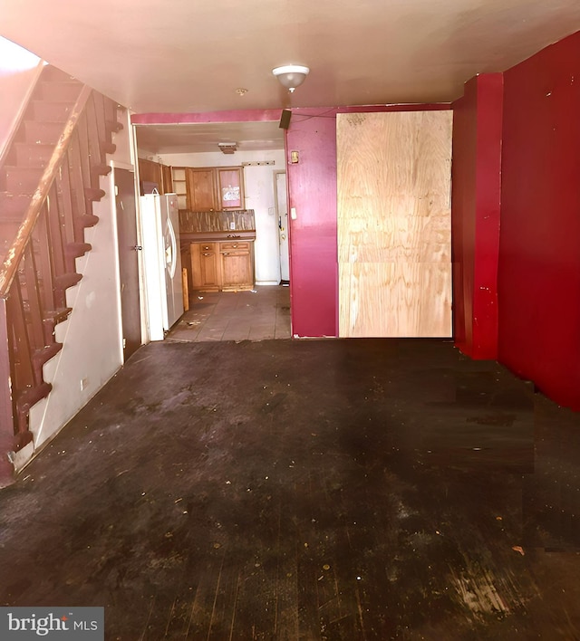 unfurnished living room with stairway