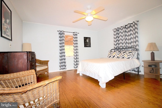 bedroom with wood-type flooring and ceiling fan