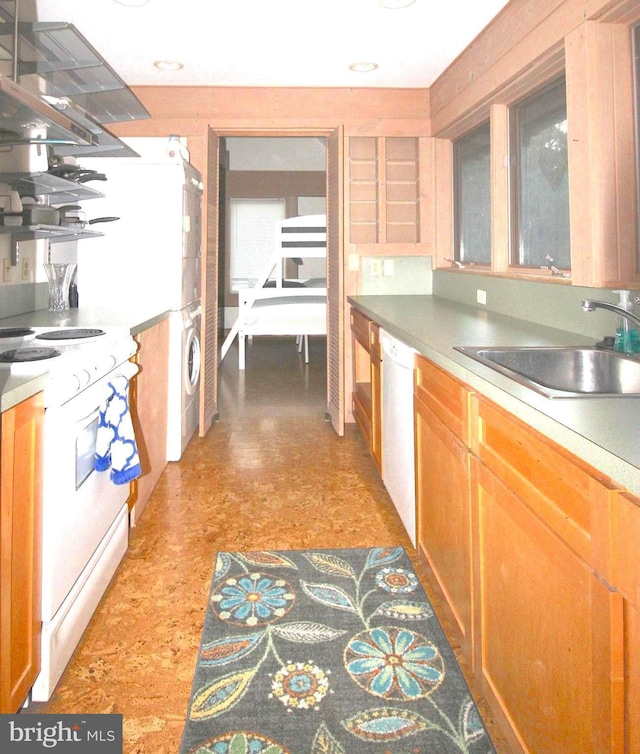 kitchen with white appliances, stacked washer and clothes dryer, sink, and island range hood