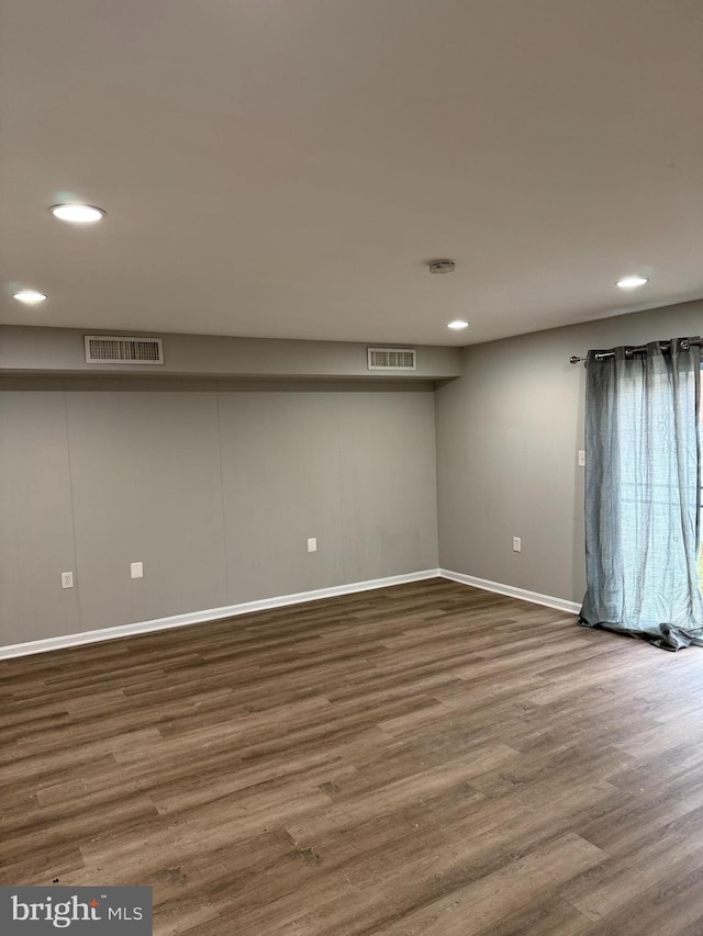 unfurnished room with wood-type flooring