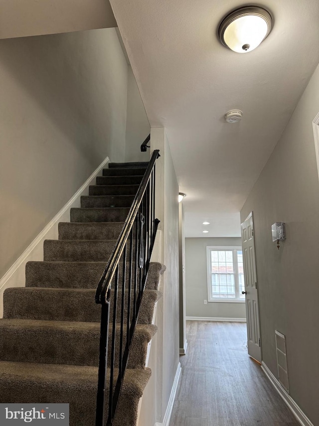 stairway featuring hardwood / wood-style floors