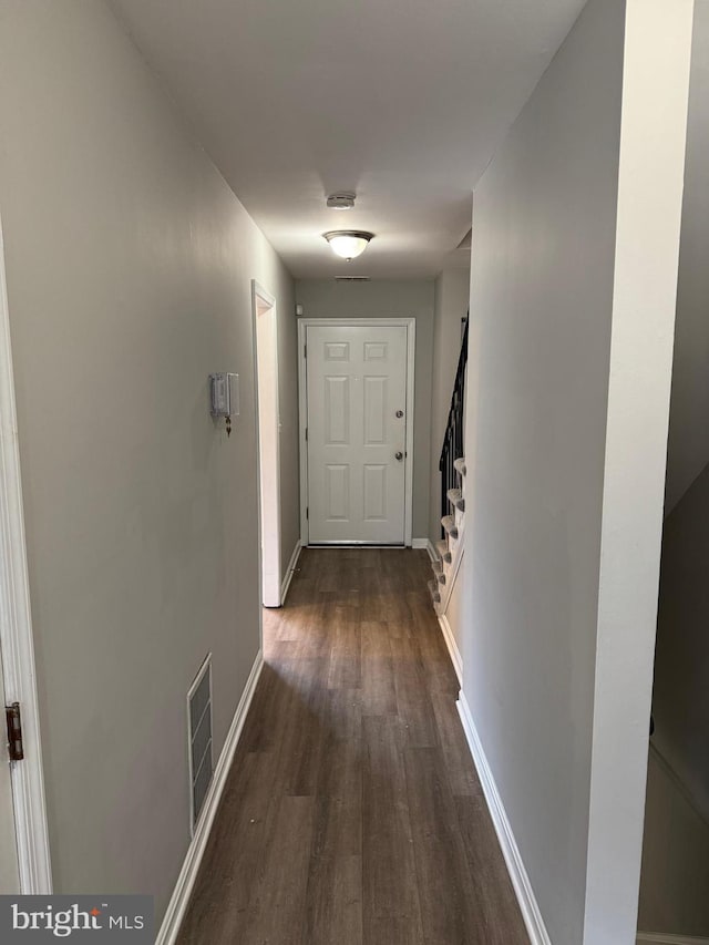 hallway featuring dark hardwood / wood-style flooring