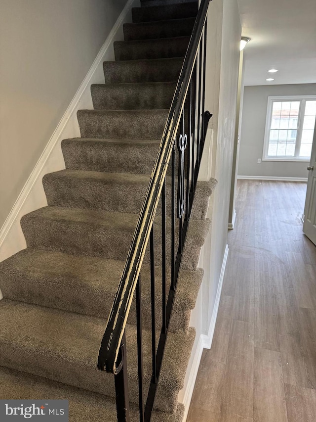 staircase featuring hardwood / wood-style floors