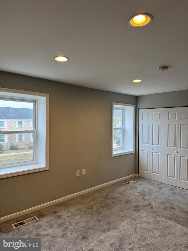 unfurnished bedroom with carpet flooring and a closet