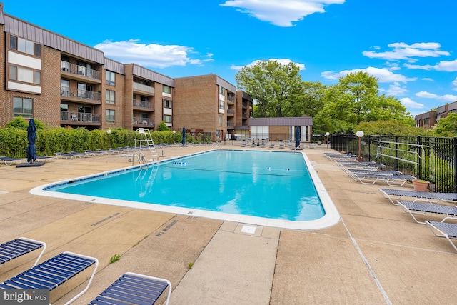 128 Roberts Ln Unit 301, Alexandria, VA 22314 - community pool featuring a patio area