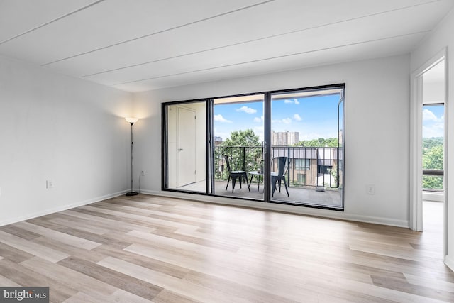 128 Roberts Ln Unit 301, Alexandria, VA 22314 - spare room featuring light wood-style flooring and baseboards