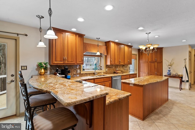 kitchen with sink, pendant lighting, and a center island