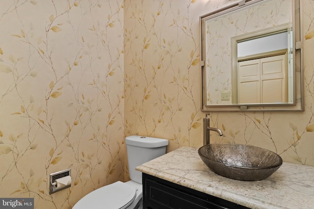 bathroom featuring toilet and vanity