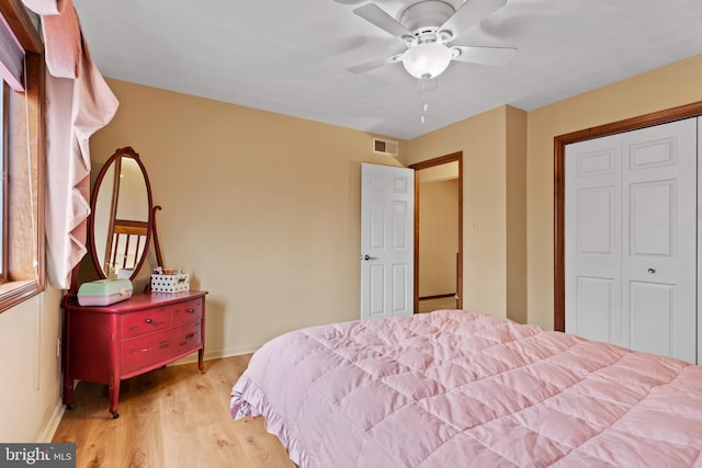 bedroom with a closet, ceiling fan, and light hardwood / wood-style flooring