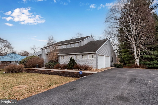 view of property exterior with a garage and a yard