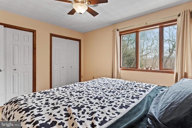 bedroom featuring multiple closets and ceiling fan