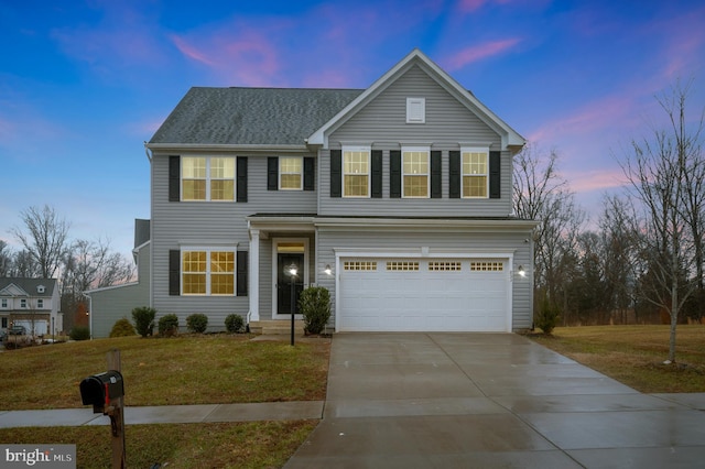 view of front facade with a garage and a lawn