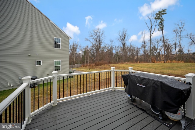 wooden terrace featuring a yard and grilling area