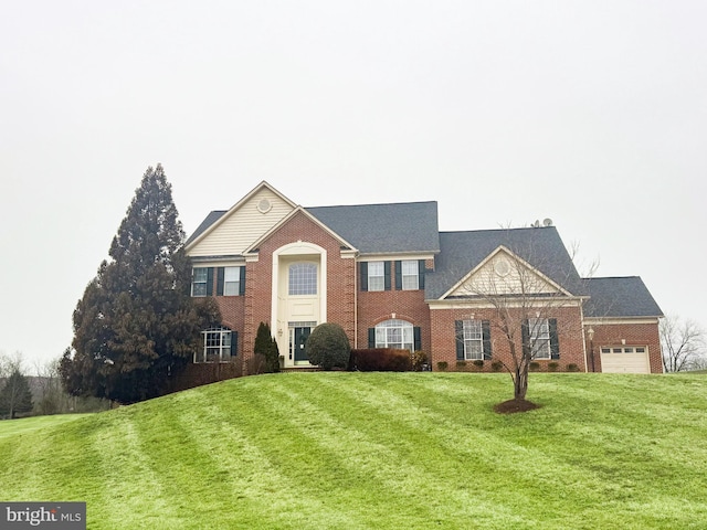 view of front facade with a garage and a front yard