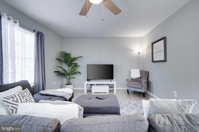 living room featuring ceiling fan and light wood-type flooring